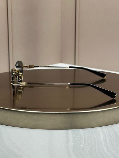 Солнцезащитные очки Miu Miu SMUA54 золотые овальные безободковые металлические, черная линза, женские