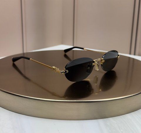 Солнцезащитные очки Miu Miu SMUA54 золотые овальные безободковые металлические, черная линза, женские