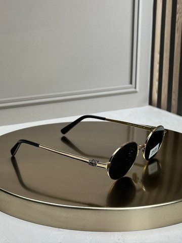 Солнцезащитные очки Miu Miu MU 50ZV золотые овальные металлические, черная линза, женские