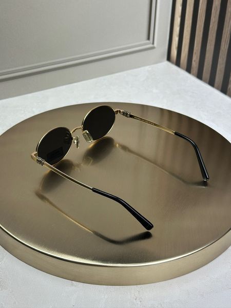 Солнцезащитные очки Miu Miu MU 50ZV золотые овальные металлические, черная линза, женские